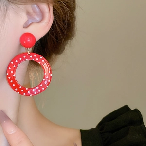 Vintage red polka dot geometric hoop earrings for women shown on a fashion model