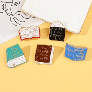 Set of five colorful book-shaped enamel pins with creative English quotes on background