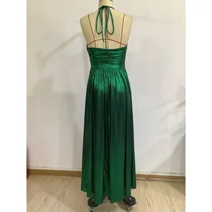 Close-up of emerald green sequin fabric showing shiny metallic texture and back lace-up detail