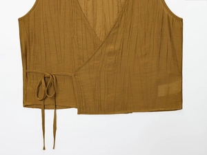 Close-up of textured ribbed crop top with side tie detail in a rich tan brown shade