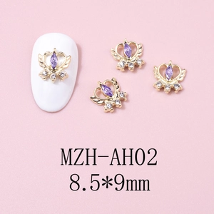 Detail of winged heart crown nail charm with purple zircon and white crystal accents