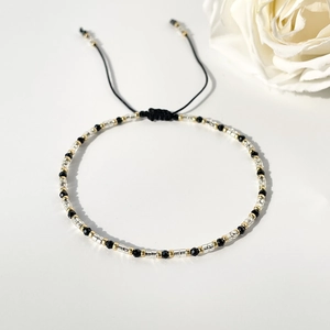 Minimalist Miyuki glass seed bead bracelet with adjustable black cord and faceted beads