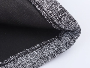 Macro shot of grey tweed fabric texture with detailed stitching and black lining