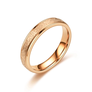 Close-up of rose gold titanium steel ring with sandblasted texture and polished edges
