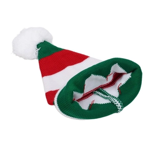 Macro detail of red and green striped Christmas knit hat with a white pompom