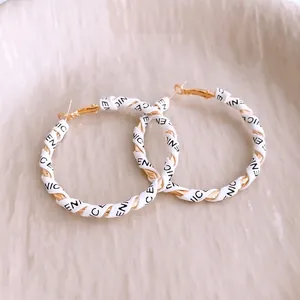 Fashionable gold hoop earrings wrapped in white leather with NICE lettering for women