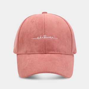 Detail of embroidered 'whatever' script on pink velvet baseball cap with curved brim