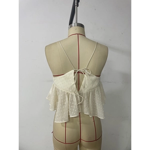 Detail of white mesh camisole featuring 3D polka dot embroidery and back tie design