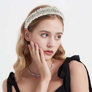 Fashionable white headband featuring layered pearls and sparkling rhinestones on fabric