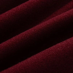 Macro shot of premium wool blend fabric texture in deep burgundy for stylish jacket