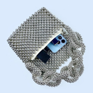 Internal view of silver beaded handbag showing capacity for phone and accessories