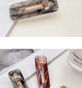 Detail showing rectangular marble texture acrylic hair clips with golden metal springs