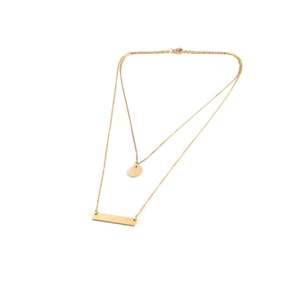 Close-up of gold double layer necklace with polished bar and round disc pendants