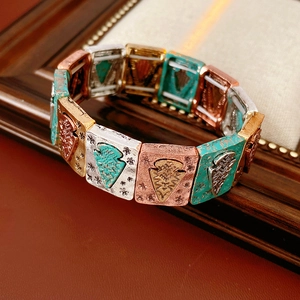Macro shot of vintage style square stretch bracelet with turquoise and bronze floral patterns