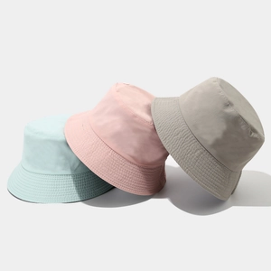 Quick-dry reversible bucket hat in mint green, pale pink, and grey with reinforced brim