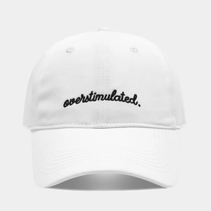 Close-up of white baseball cap with overstimulated embroidery and classic curved brim