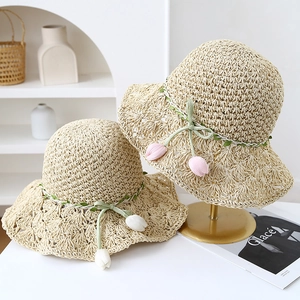 Elegant wide-brim hand-woven straw sun hat with decorative floral ribbon for summer