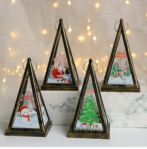 Detail of four bronze Christmas LED lanterns with festive reindeer and Santa patterns