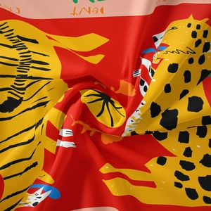 Detail of red Bohemian tapestry showing leopard and zebra patterns on twill fabric texture