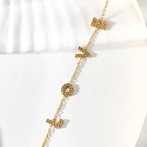 Detail of gold-plated stainless steel chain with zircon-studded LOVE letter pendant
