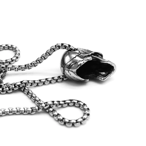 Detailed close-up of a vintage silver skull pendant on a durable stainless steel box chain