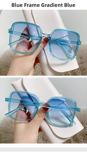 Detail of square gradient blue sunglasses with integrated nose pads and white leather case