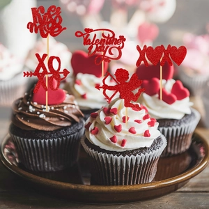 Red glitter Valentine's Day cupcake toppers with Kiss Me and XOXO text on cakes