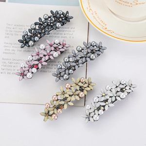 Five-piece set of elegant flower hair clips with pearls and rhinestones on white background
