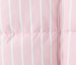 Detailed macro view of pink and white striped fabric and matching resin zipper closure