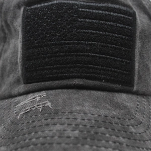 Macro detail of distressed washed denim baseball cap with American flag velcro patch