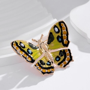 Colorful enamel butterfly brooch with crystals on a white geometric display