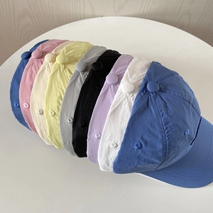 Row of lightweight quick-dry nylon baseball caps in various pastel colors and styles