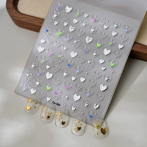 Macro view of Co-369 nail stickers featuring 5D gold and silver heart star patterns