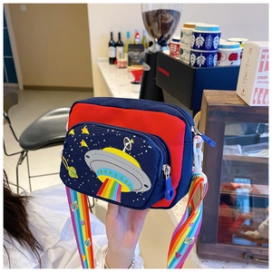 Detail of canvas kids crossbody bag with rainbow strap and cartoon UFO embroidery