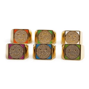 Flat lay view of colorful enamel smiley face rings with cubic zirconia inlay in gold finish