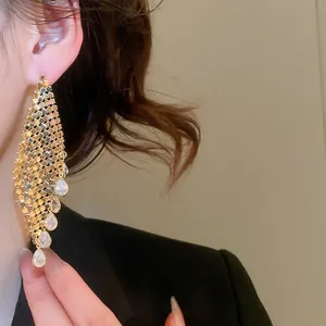 Luxurious gold-plated mesh earrings with cubic zirconia water drop tassels on female model