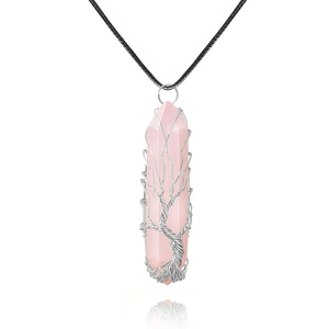 Detail of rose quartz hexagonal pendant wrapped in silver wire tree of life design