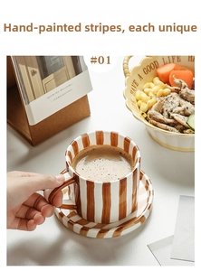 Close-up of hand-painted ceramic coffee mug with vintage brown stripes and thick handle