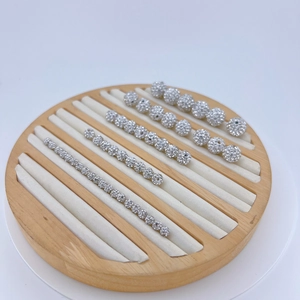 Silver 4mm-12mm cubic zirconia round spacer beads displayed on a wooden tray for DIY jewelry