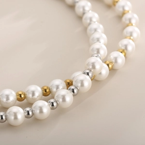 French style double-layer faux pearl and gold-silver beaded necklace on beige background