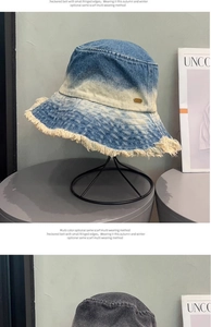 Detailed macro view of denim bucket hat featuring gradient wash and stylish fringed edges