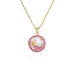 Macro view of gold-plated Aries pendant with pink zircons and mother-of-pearl inlay