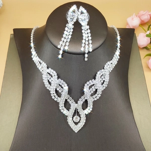 Silver bridal jewelry set featuring a V-shaped rhinestone necklace and drop earrings
