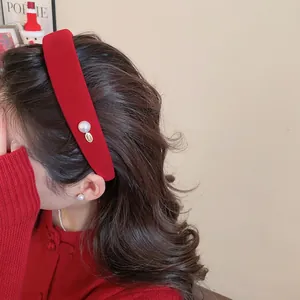 Retro red velvet headband with pearl accent and gold pendant for festive winter styling
