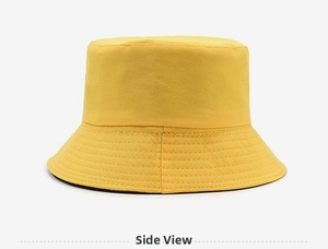 Side view detail of a yellow cotton bucket hat showing precise brim stitching lines