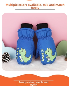 Close-up of blue winter mittens for kids with cartoon dinosaur print and knit cuffs