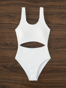 Detail of white ribbed one-piece swimsuit featuring waist cutouts and high-cut leg