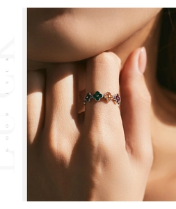 Close-up of a s925 silver ring featuring colorful enamel lucky clover flower patterns