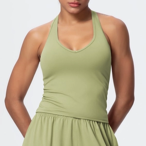 Detail of olive green athletic yoga set featuring cross-back vest and fitted shorts