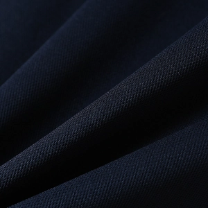 Close-up of navy blue breathable mesh fabric texture and knit detail on polo shirt